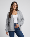 Women's oversized V-neck cardigan in gray worn over a white top with jeans
