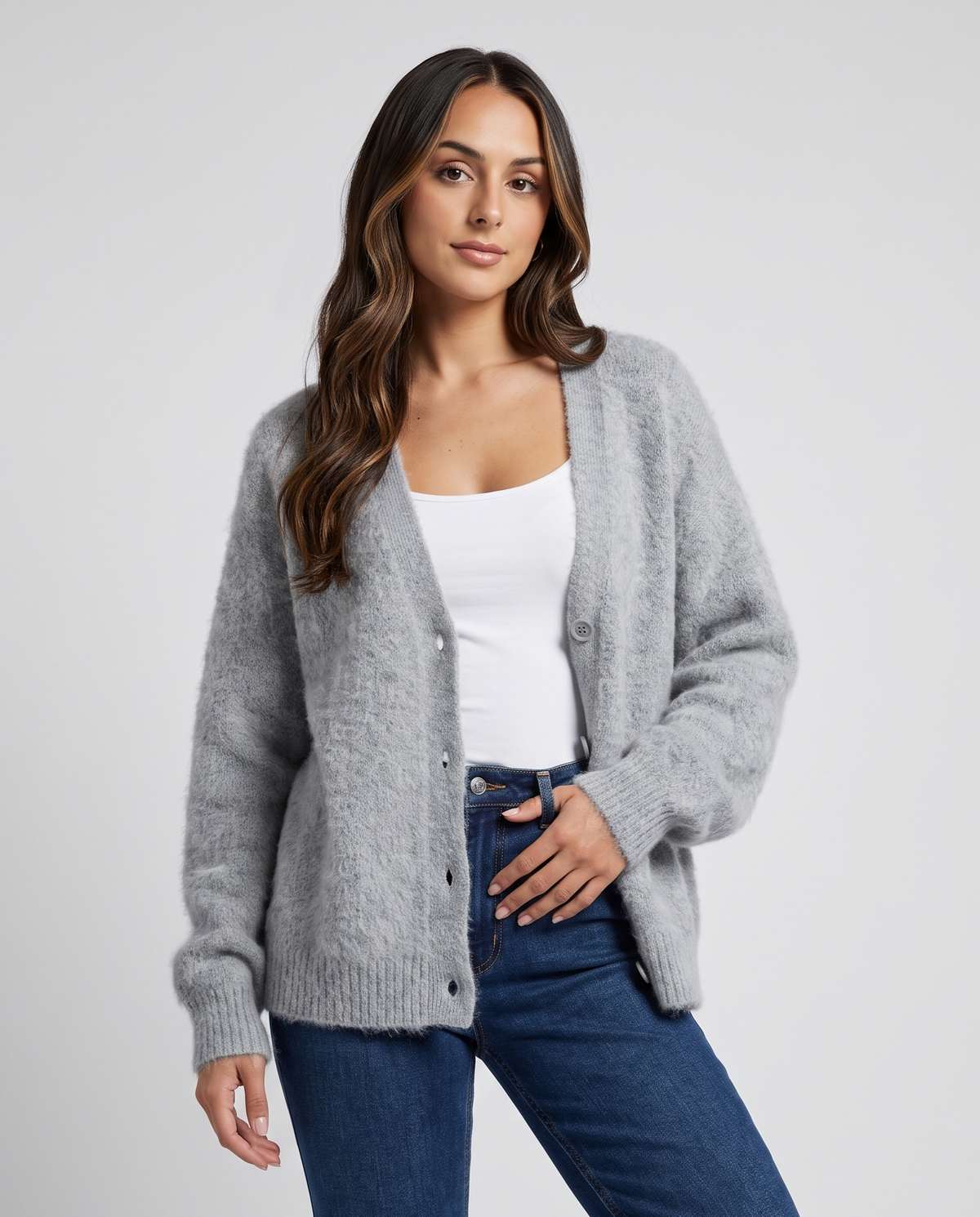 Women's oversized V-neck cardigan in gray worn over a white top with jeans