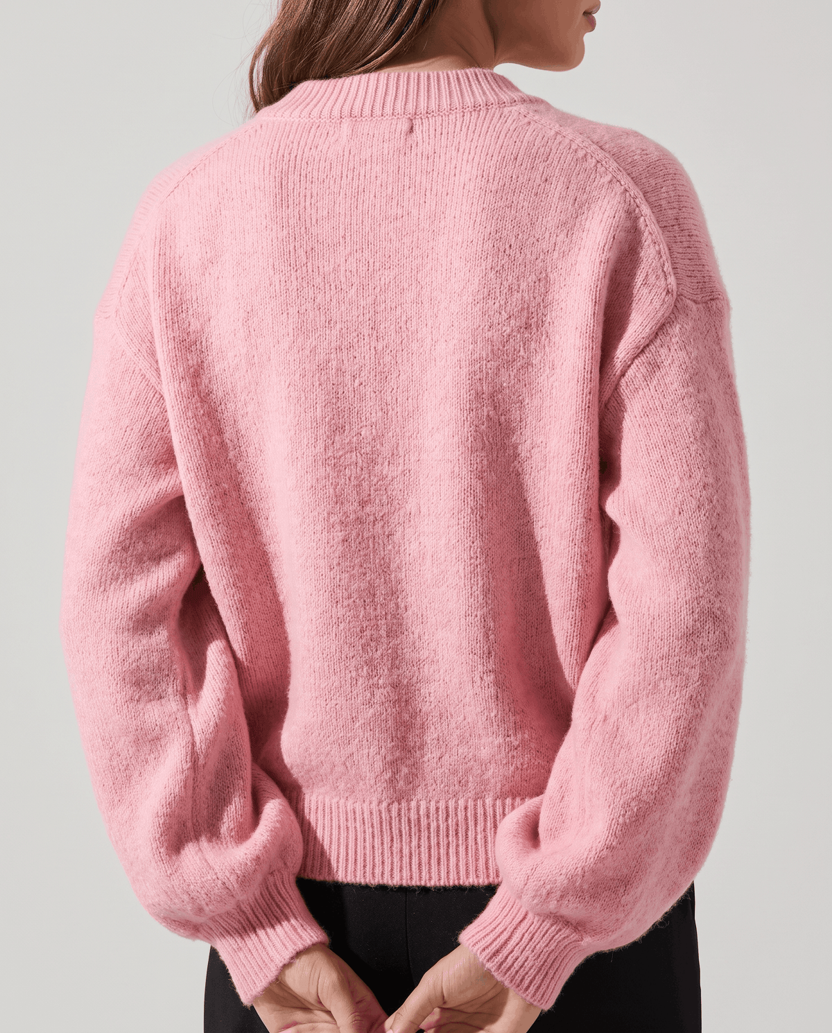 Back view of the pink cardigan with dropped shoulders and gathered balloon sleeves