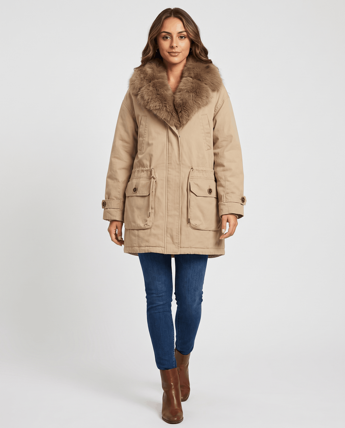 Full-length view of khaki parka with cargo pockets, blue jeans and boots