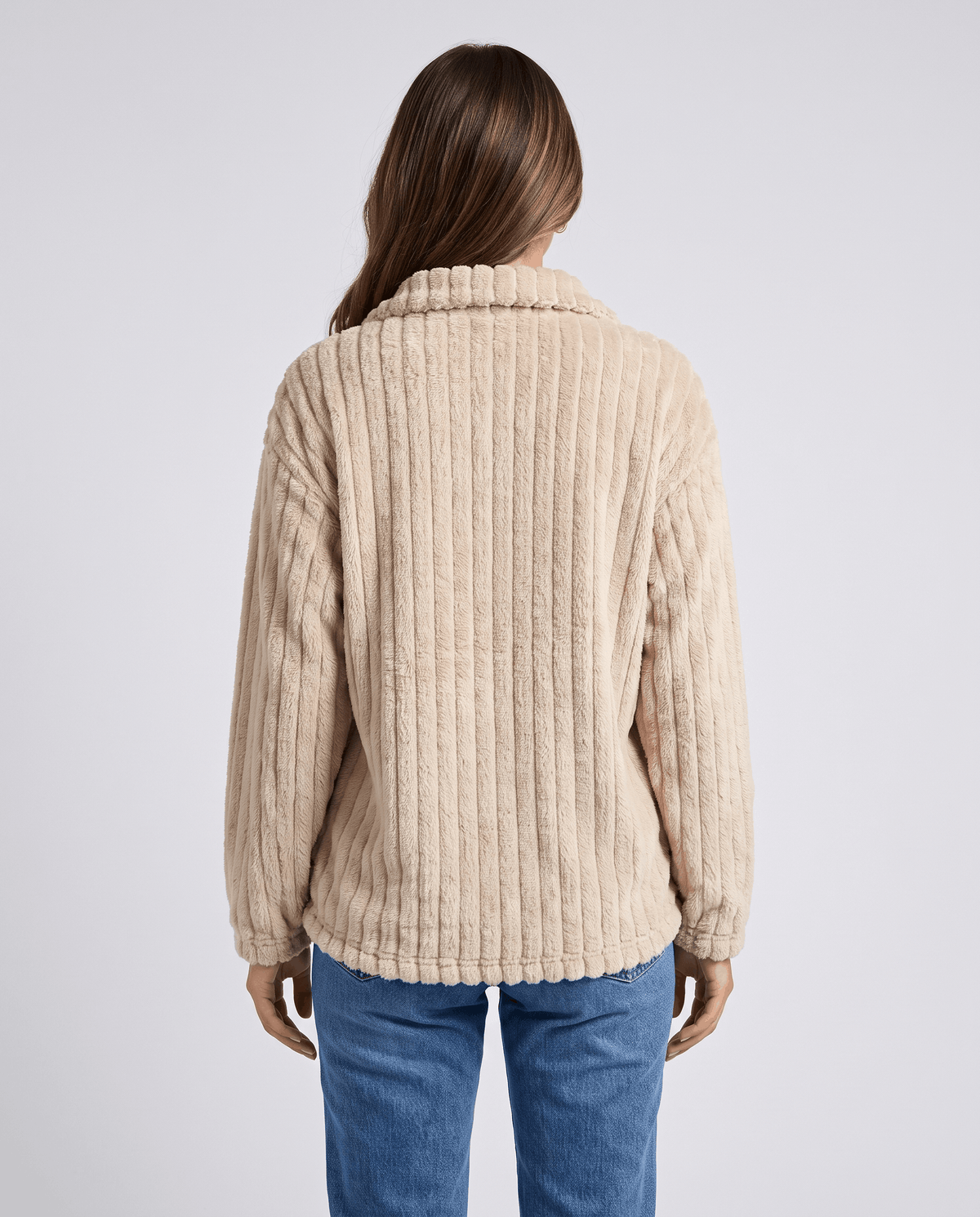 Back view of beige plush pullover showing vertical ribs and relaxed long sleeves