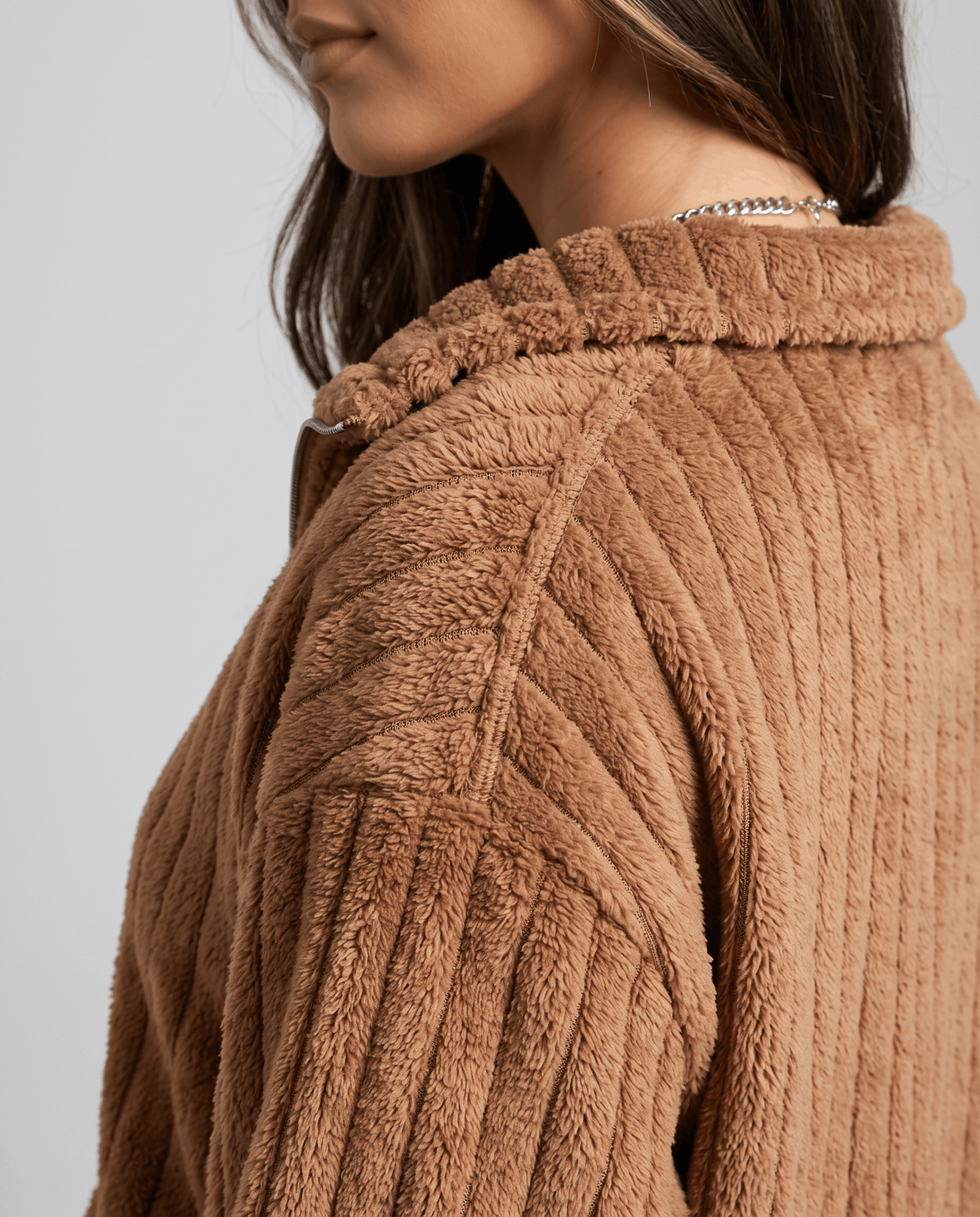Close-up of camel brown plush ribs and folded stand collar