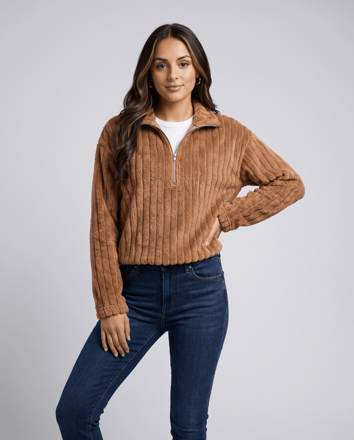 Front view of camel brown plush pullover worn with medium wash jeans