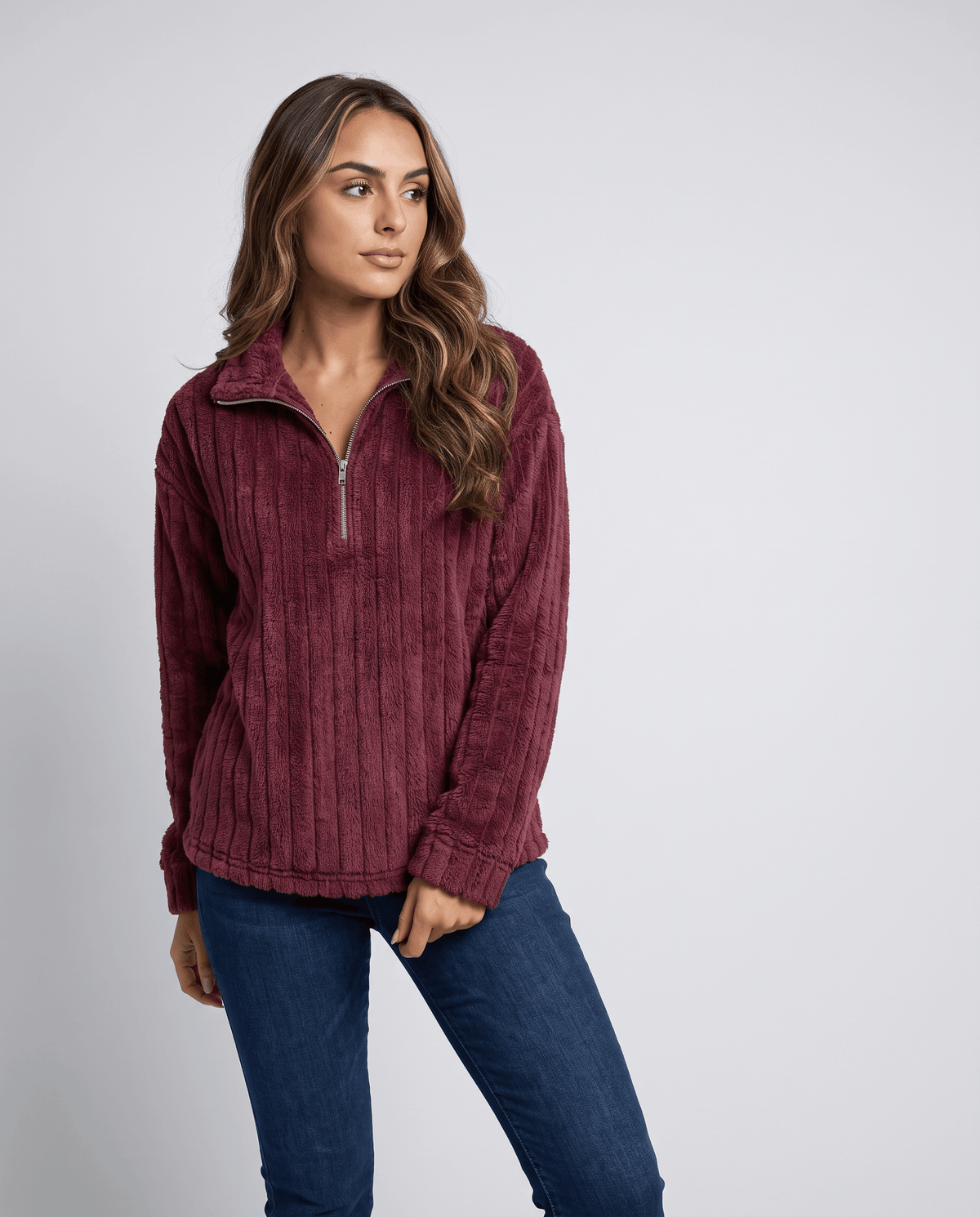 Front view of burgundy red plush pullover worn with dark wash jeans