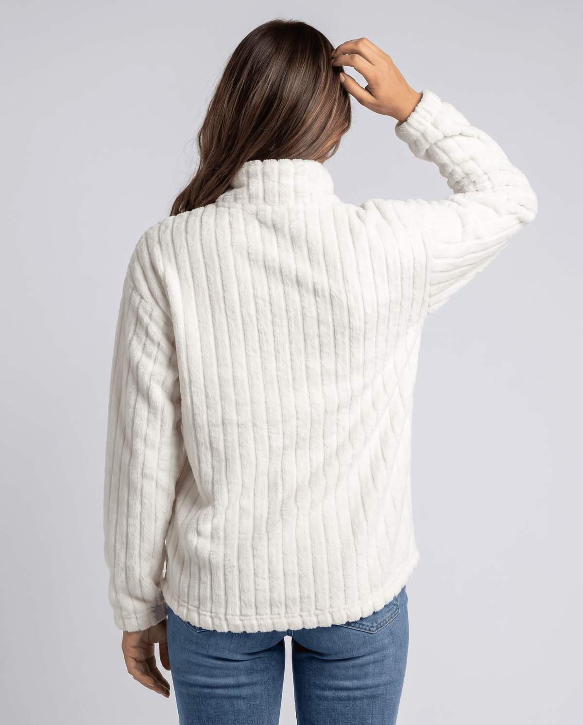 Back view of white plush pullover showing ribbed texture and relaxed fit