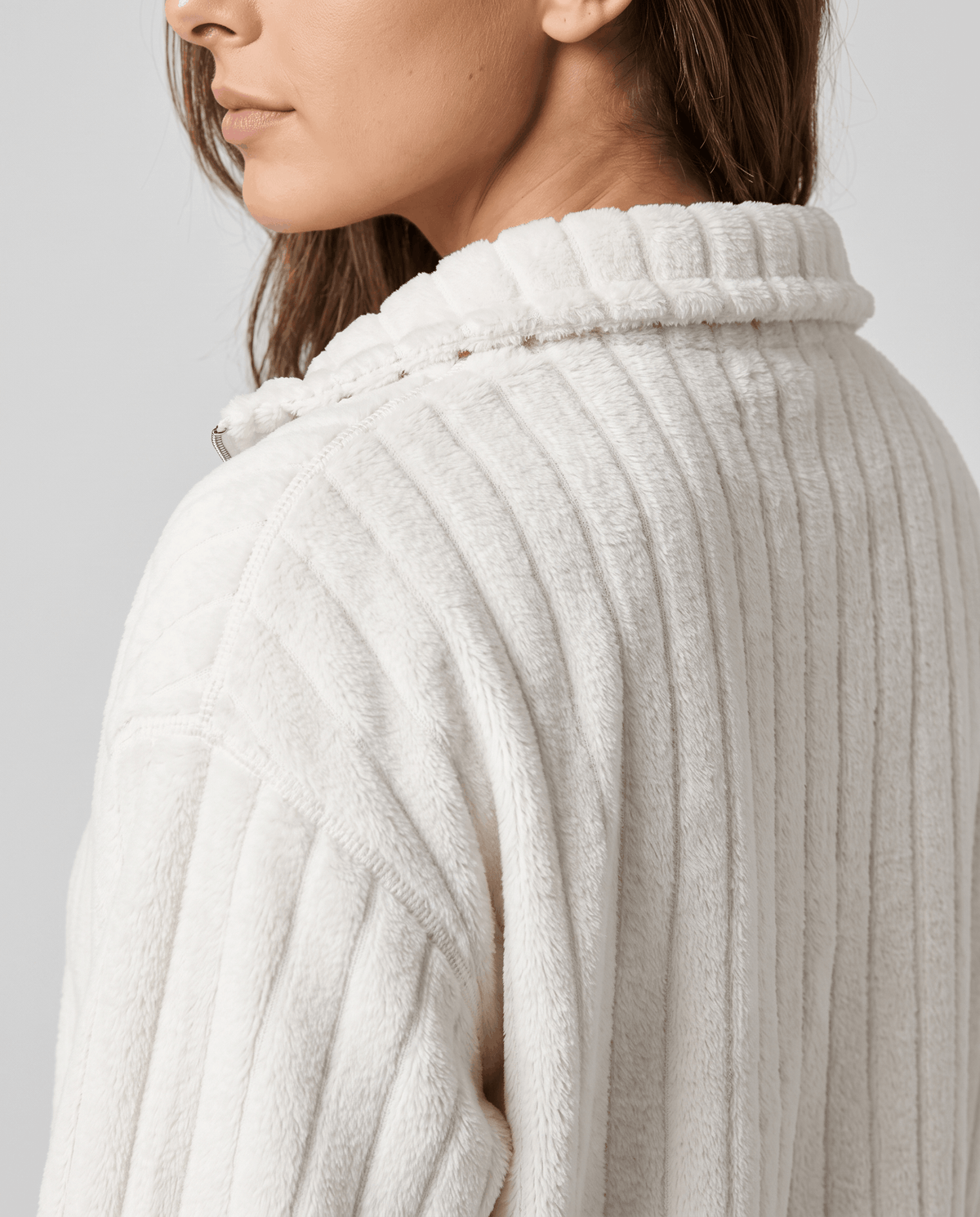 Shoulder detail showing soft ivory white plush ribs and stand collar