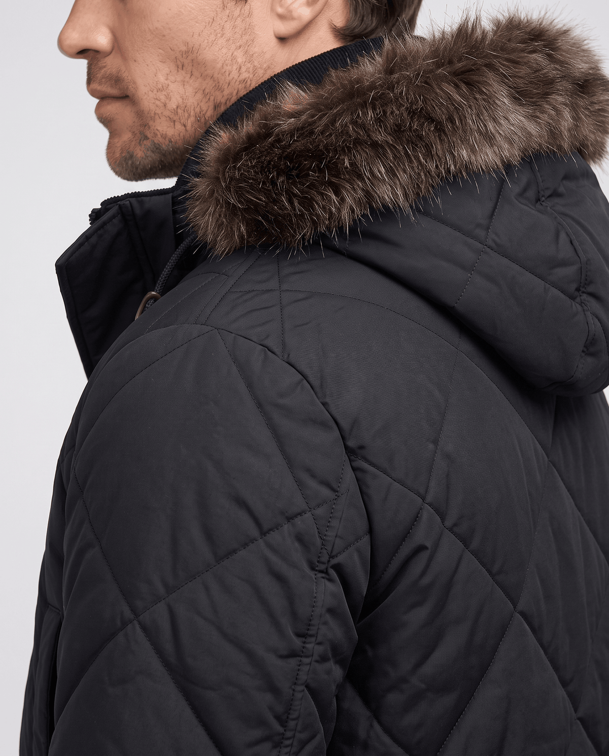 Men's black quilted long parka, fur-trim hood detail