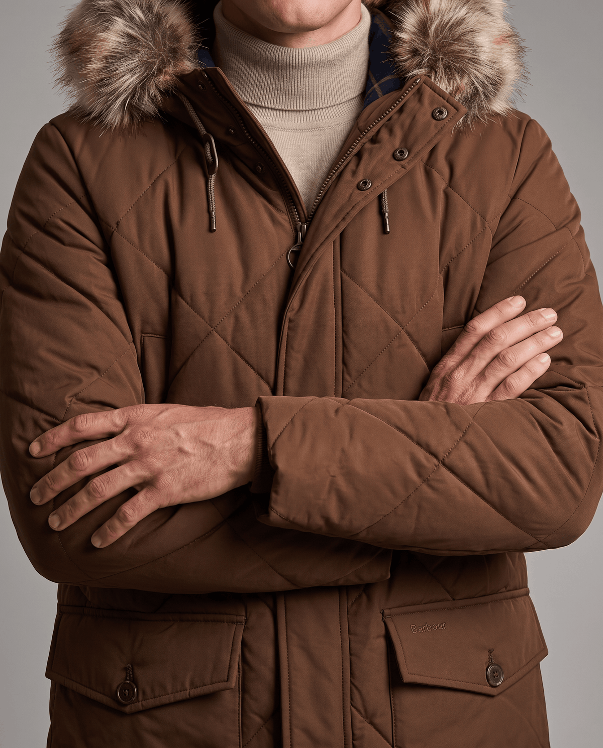Men's brown quilted long parka, front close-up showing flap pockets