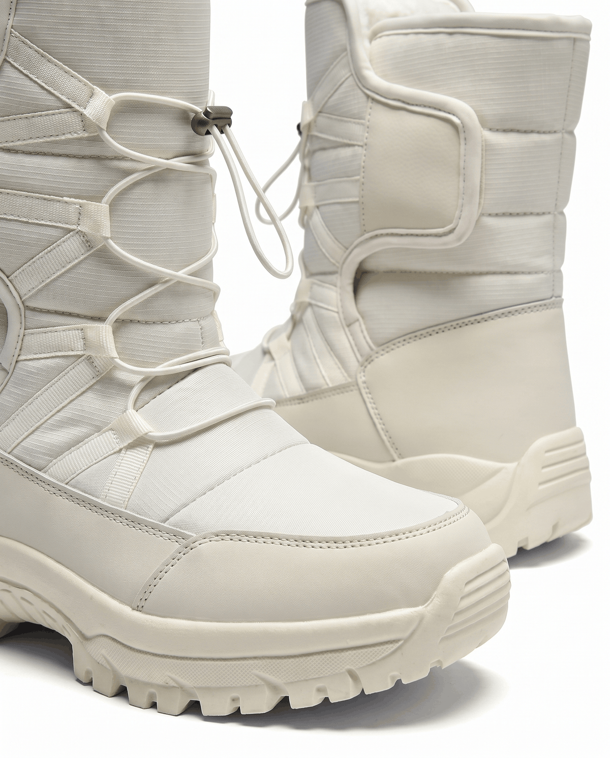 Close view of beige quilted boot showing drawstring cord and thick lug sole