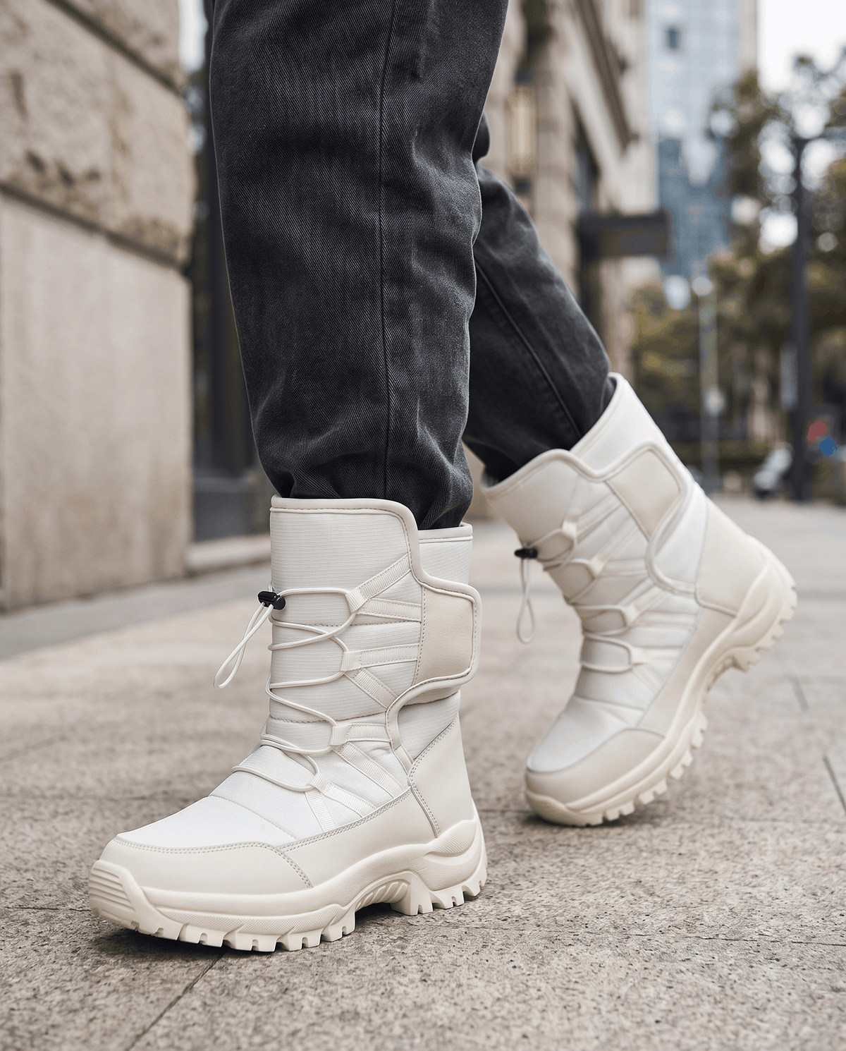 Beige quilted lug-sole boots worn with dark jeans while walking on a street