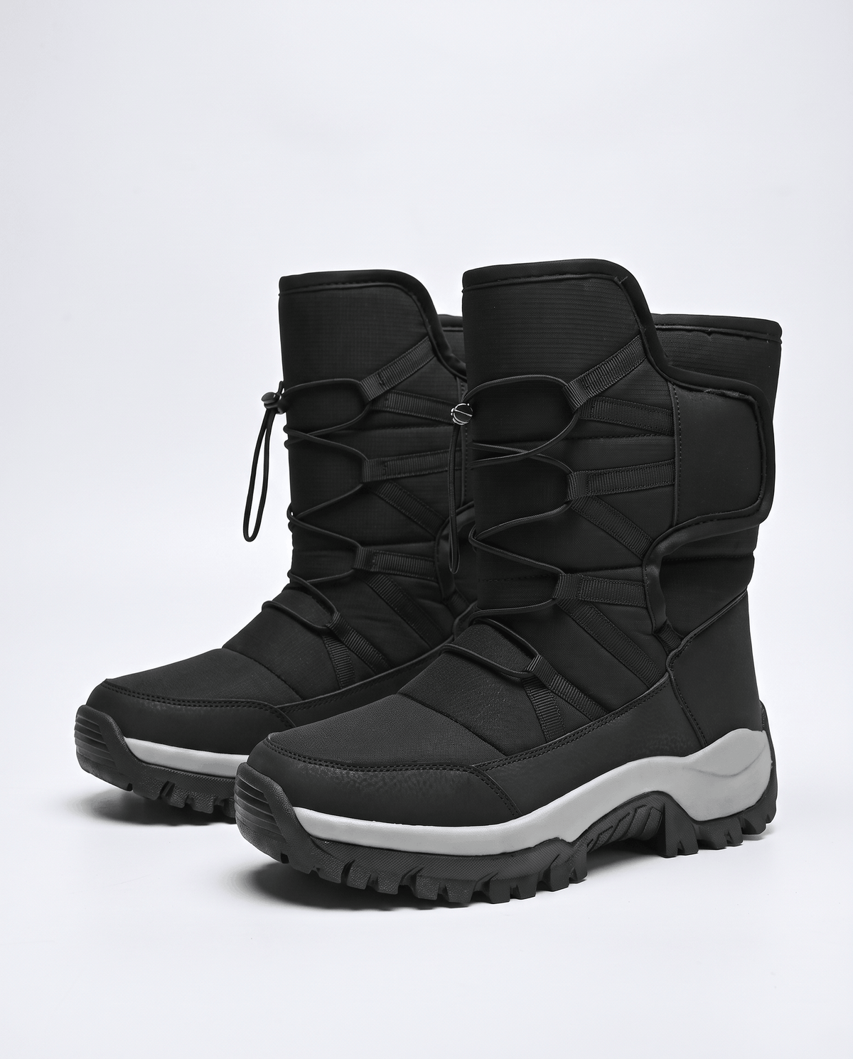 Pair of black quilted boots angled to show cord tops and thick lug soles