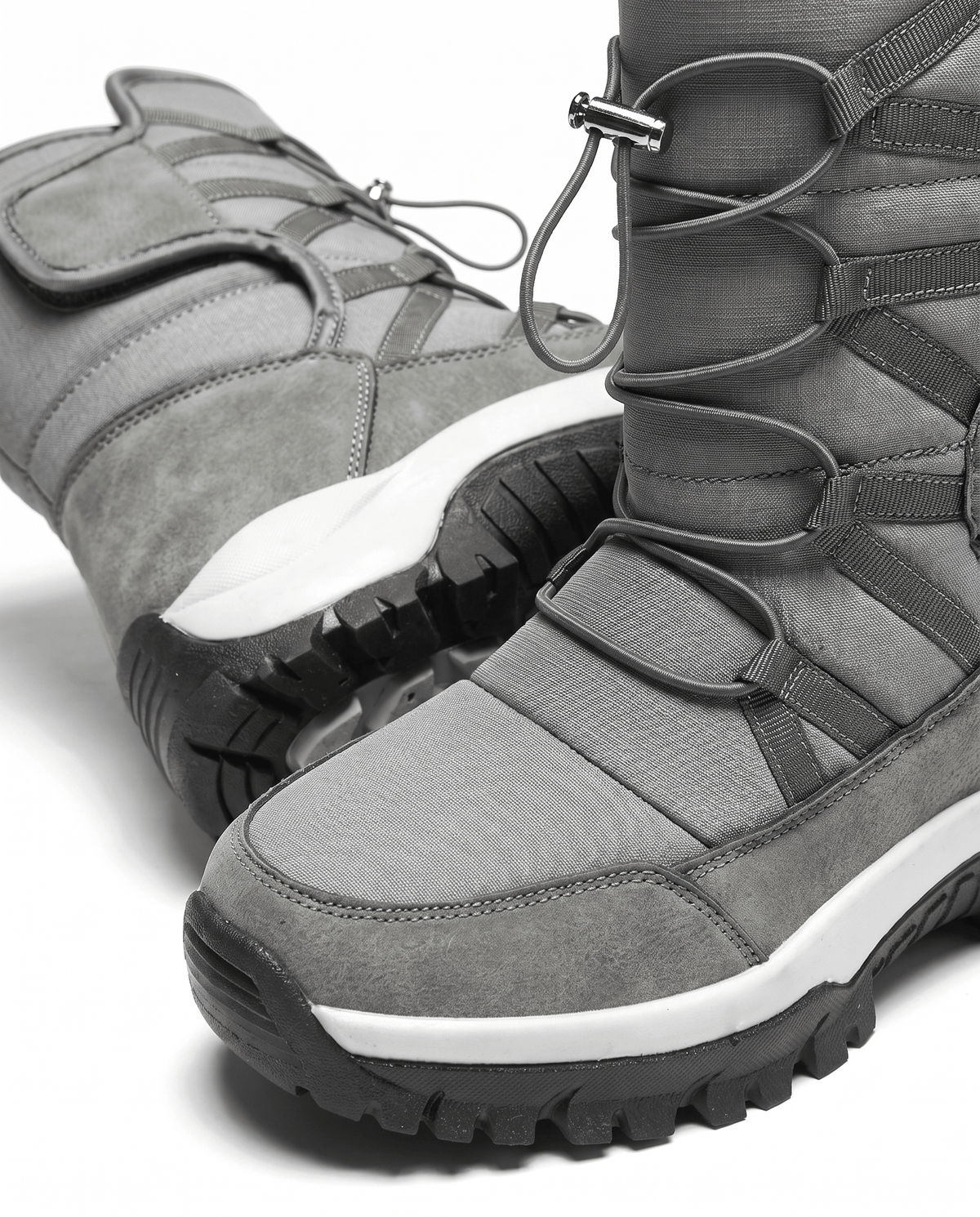 Close view of gray quilted boot with drawstring cord and thick lug sole