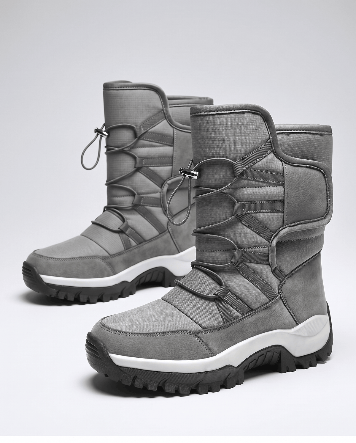Pair of gray quilted boots angled to show drawstring tops and chunky black soles