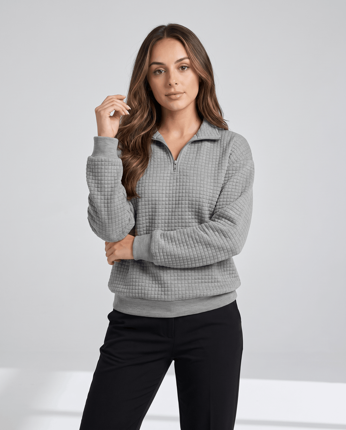 Front view of gray grid-textured pullover worn with black pants