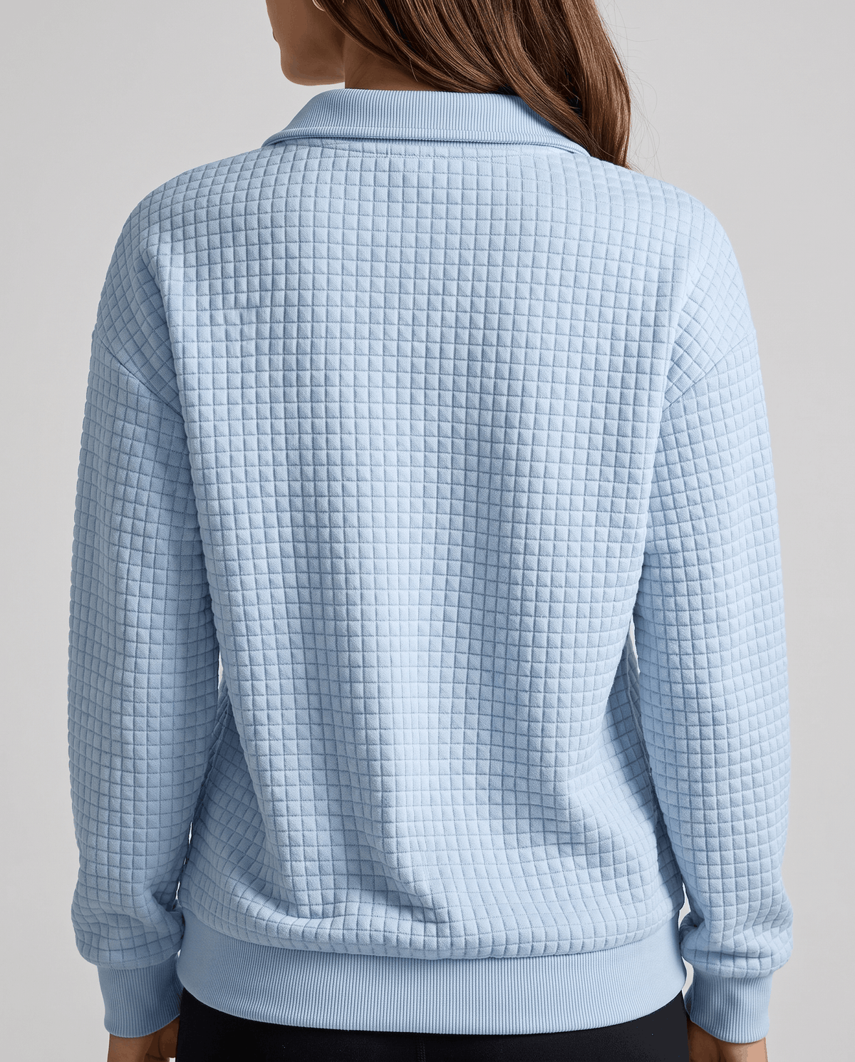 Back view of sky blue grid-textured pullover with ribbed cuffs and hem