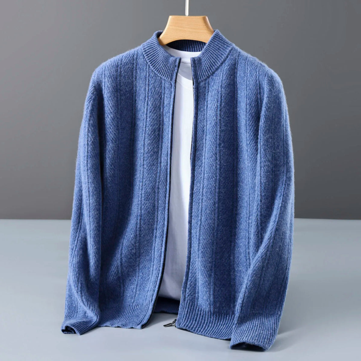 Blue ribbed zip cardigan hanging open on a wooden hanger