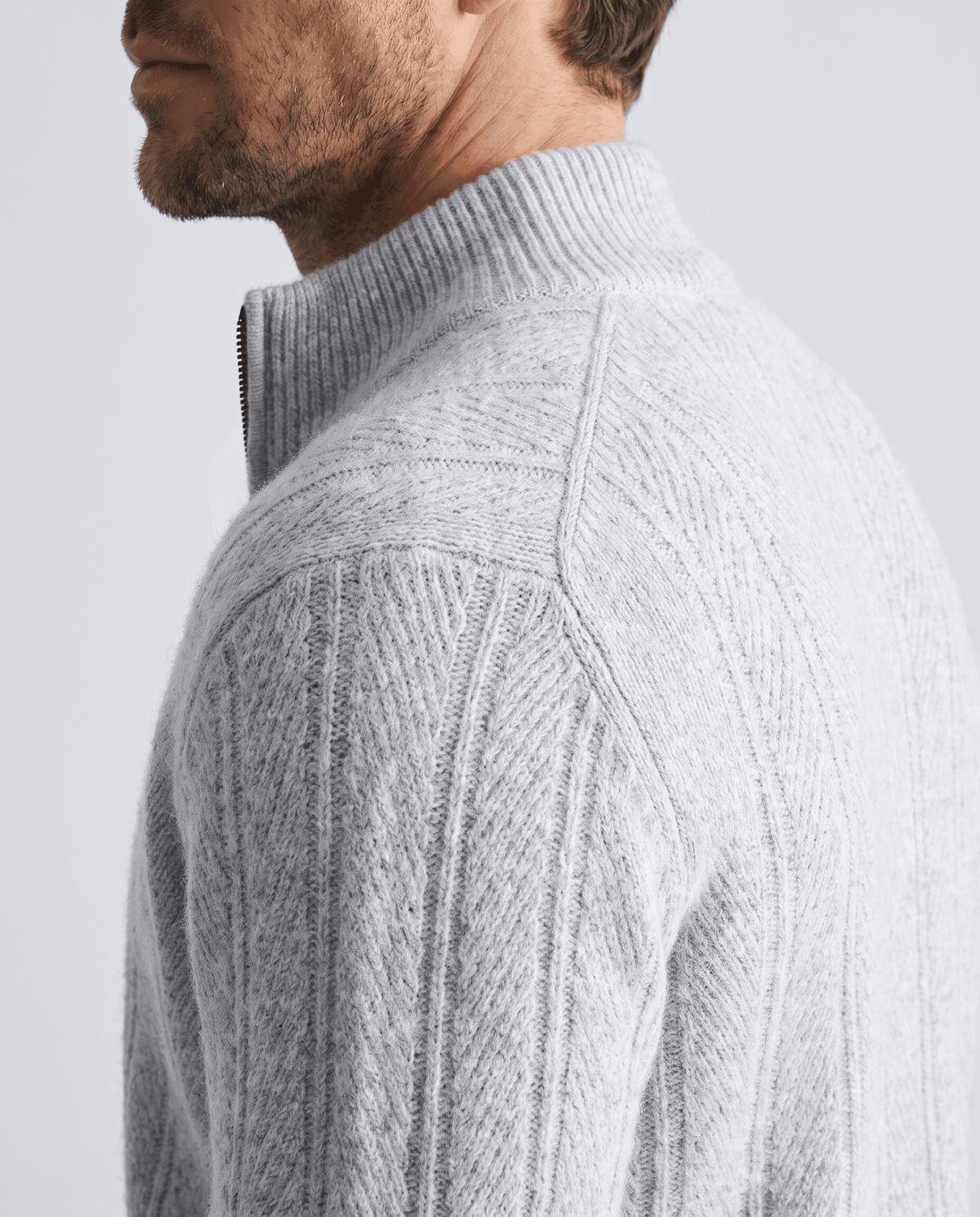 Shoulder detail of the light gray cardigan showing its vertical ribbed knit