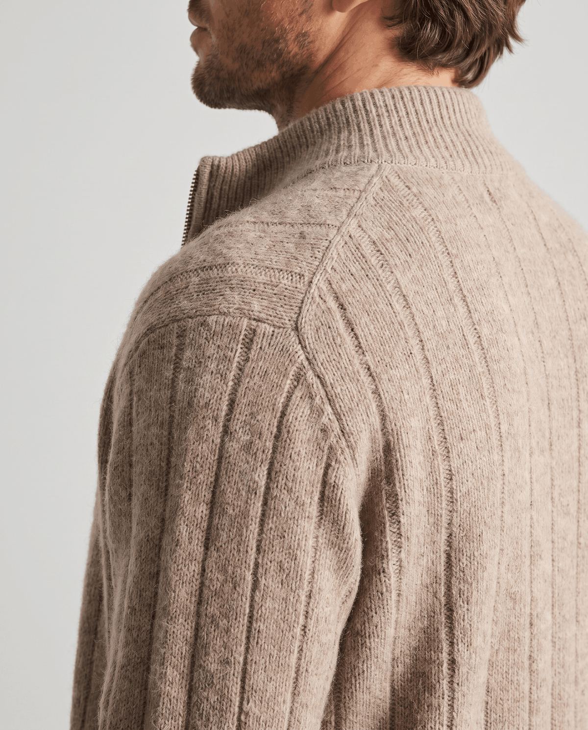 Shoulder detail of the taupe cardigan showing the vertical ribbed knit
