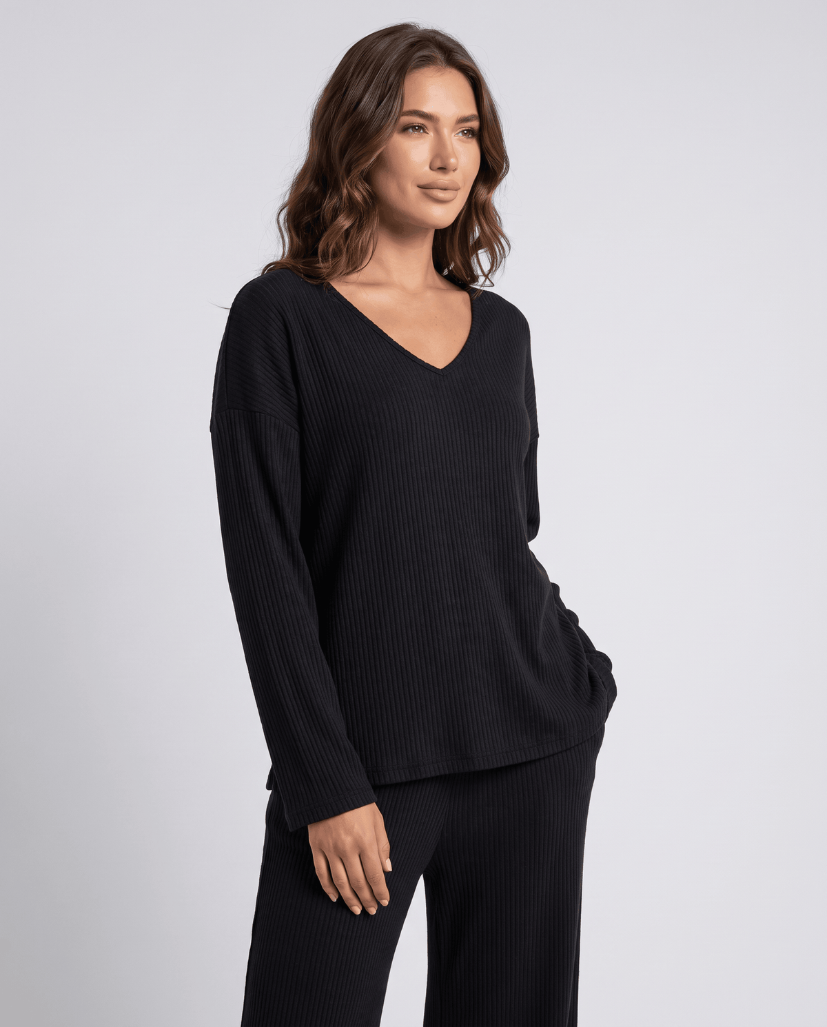 Black ribbed knit V-neck top with long sleeves, close front view