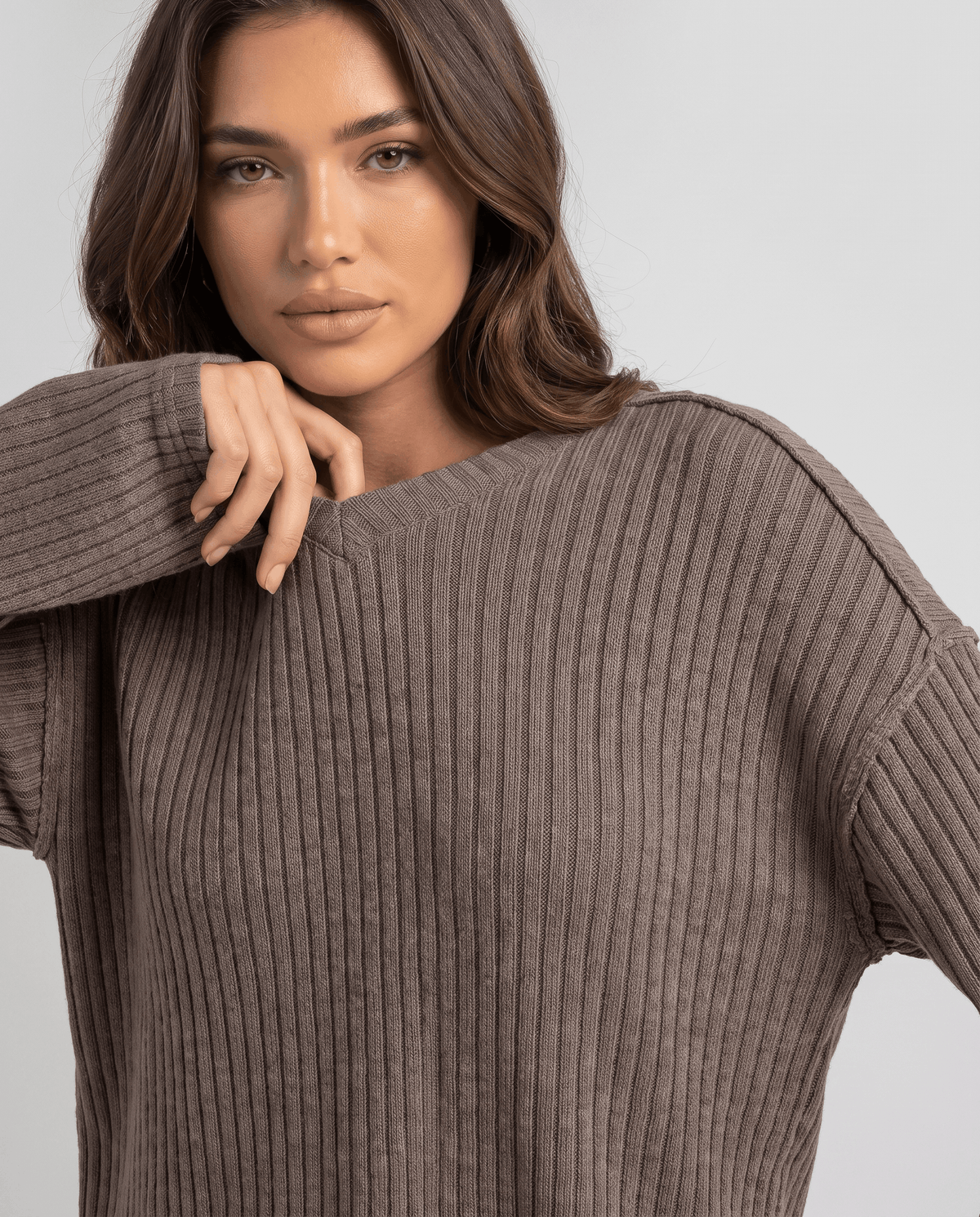 Close-up of the brown ribbed knit top with long relaxed sleeves