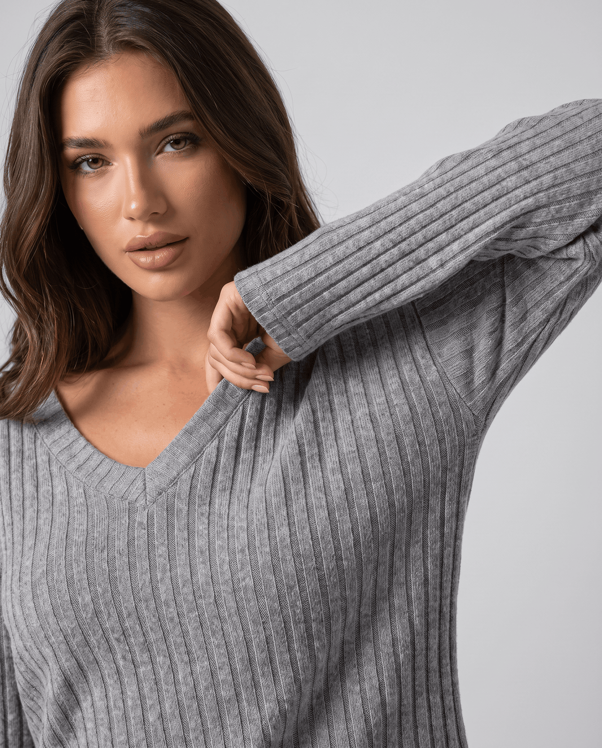 Close-up of the grey ribbed knit V-neck top and long sleeve