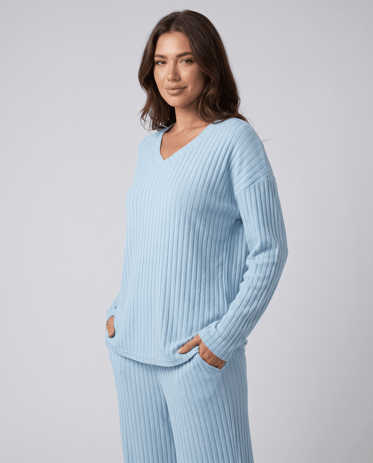 Light blue ribbed knit V-neck top with relaxed long sleeves, three-quarter view