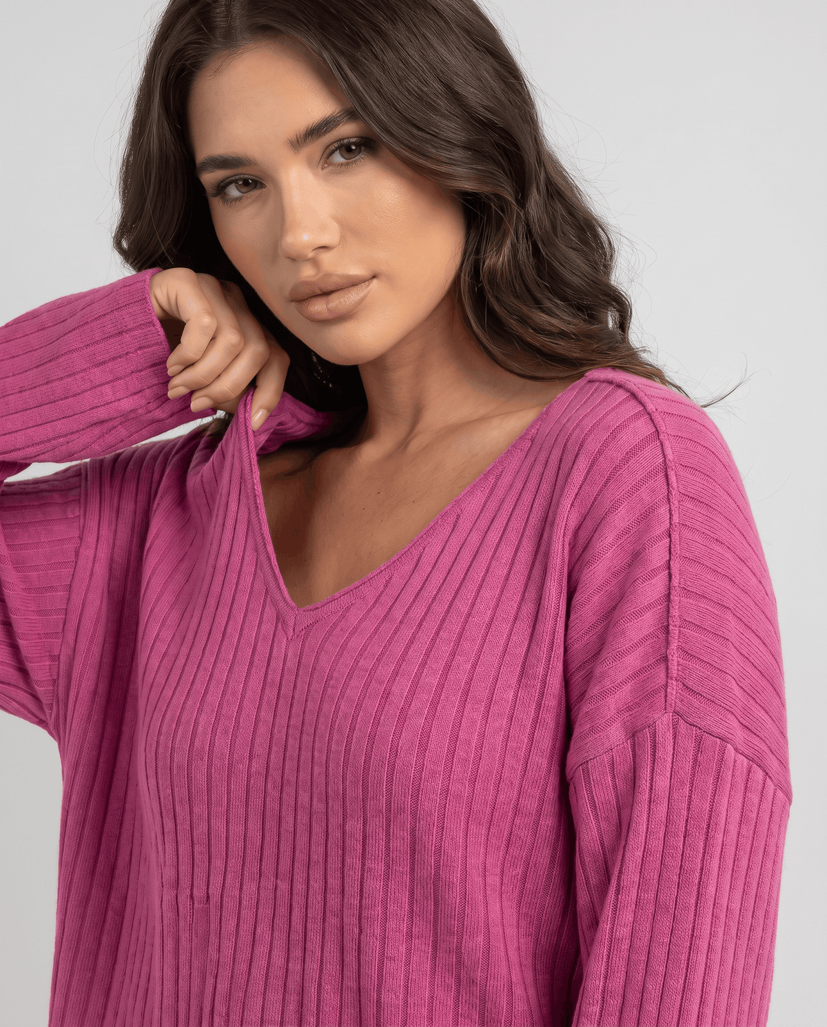 Close-up of the pink ribbed knit V-neck top with long sleeves