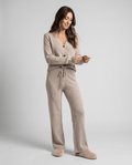Woman wearing a beige ribbed knit V-neck cardigan loungewear set with matching wide-leg pants, front view
