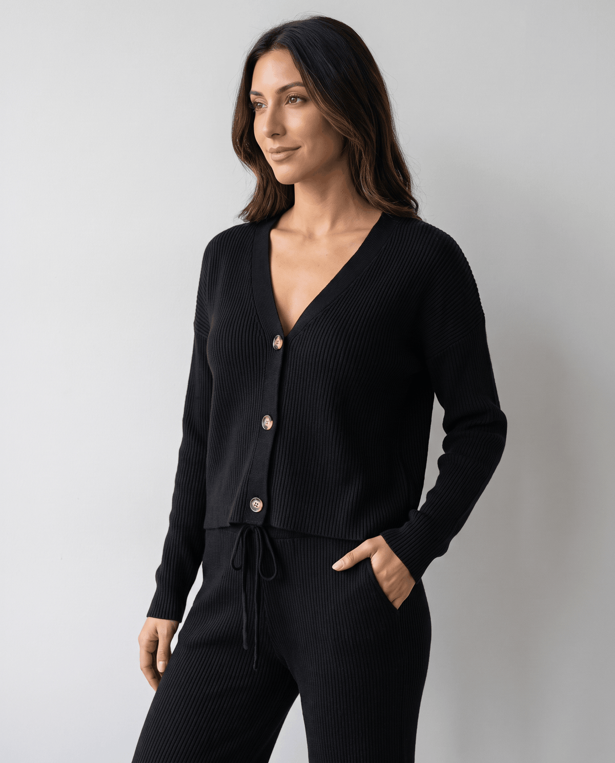 Black loungewear set three-quarter view showing the drawstring waist and pocket