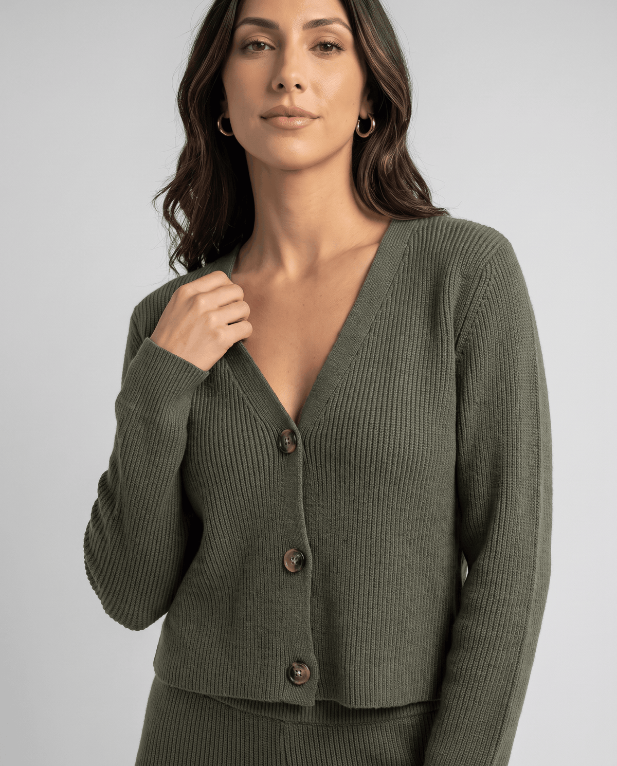Olive green knit cardigan close-up showing the V-neck and front buttons