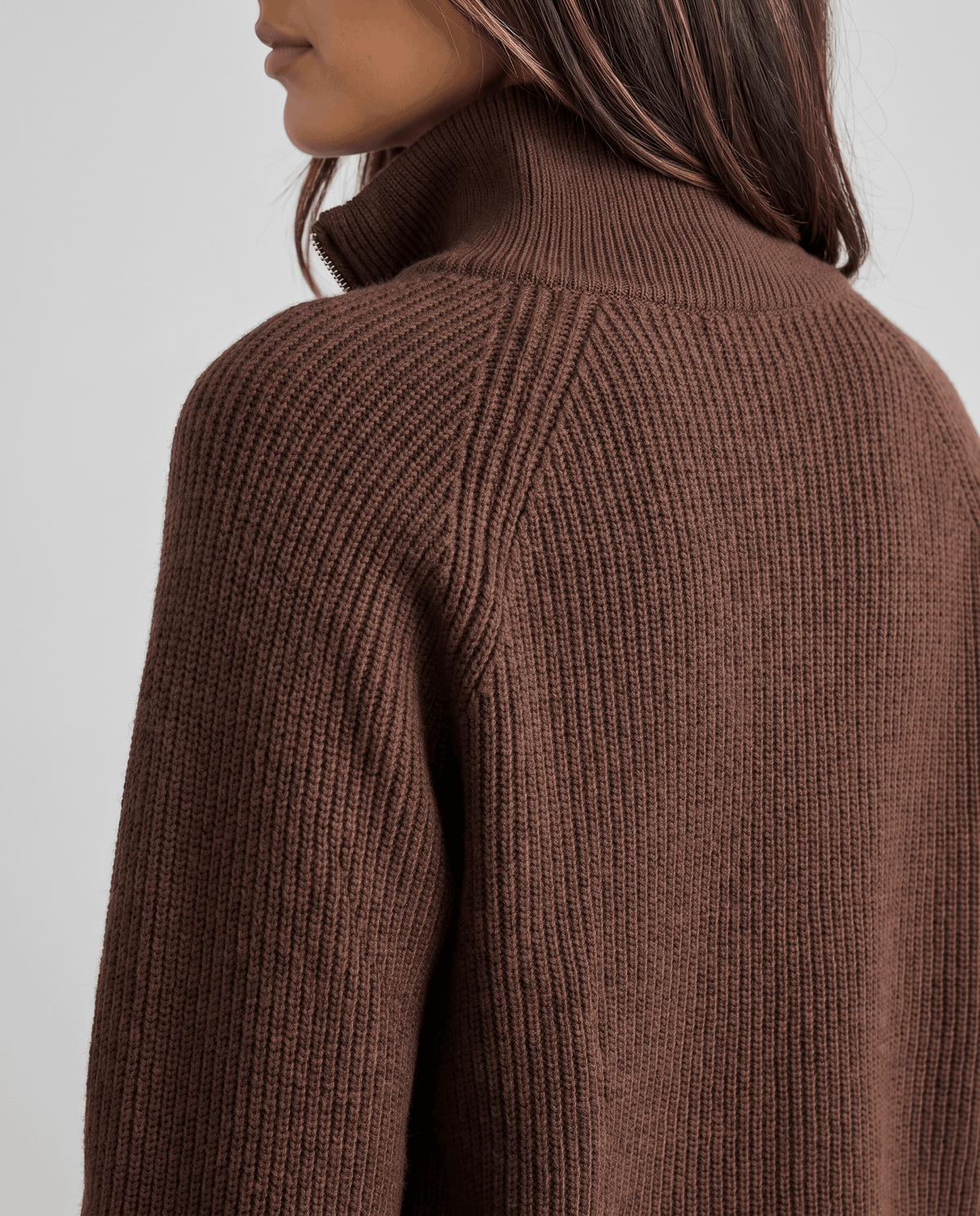 Rear shoulder detail of brown sweater showing the ribbed raglan sleeve