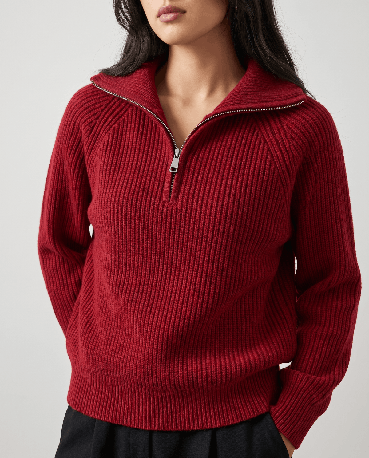 Close-up of red sweater zip and collar worn over a black skirt