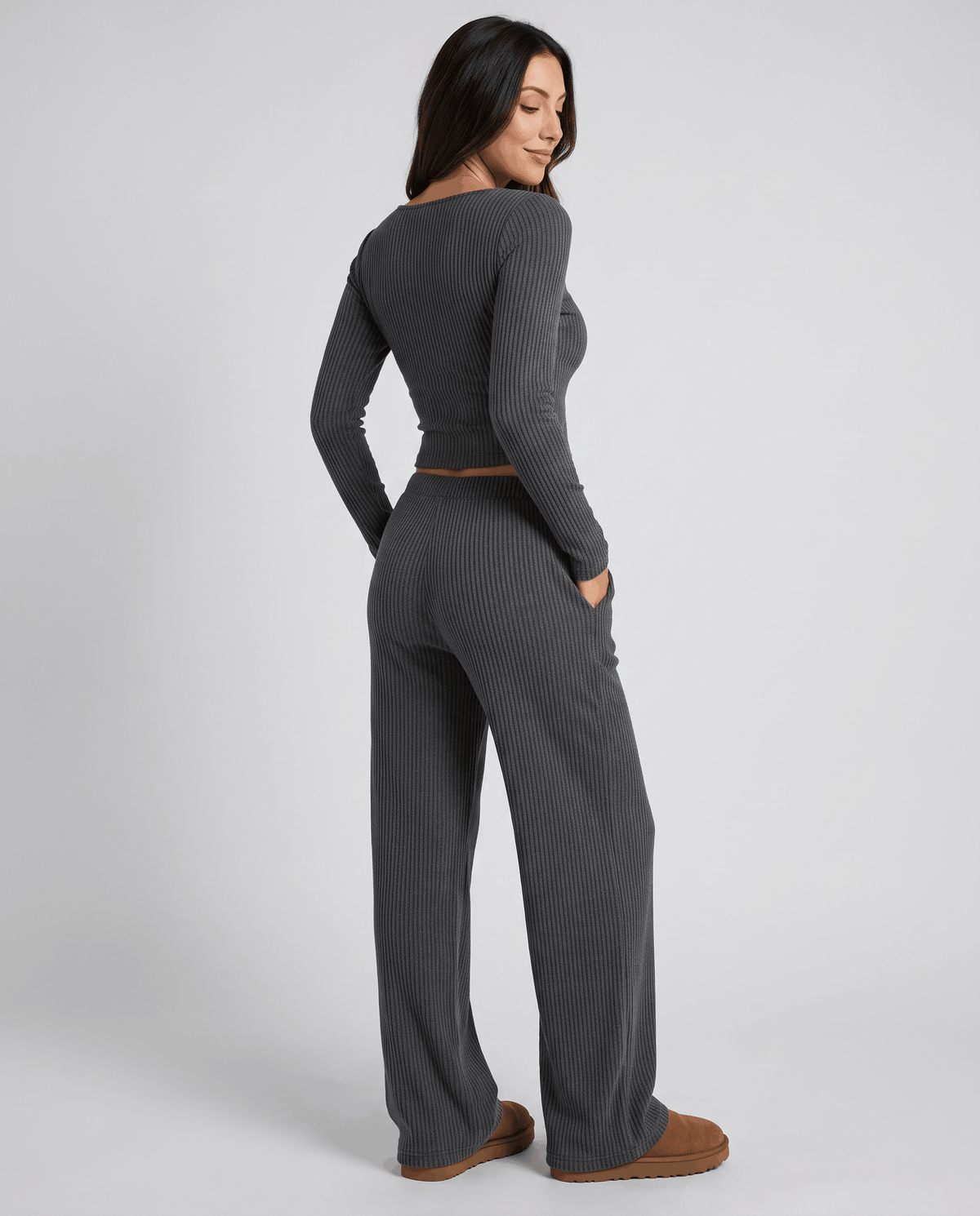 Back view of the dark gray ribbed top and wide-leg pants worn with brown shoes