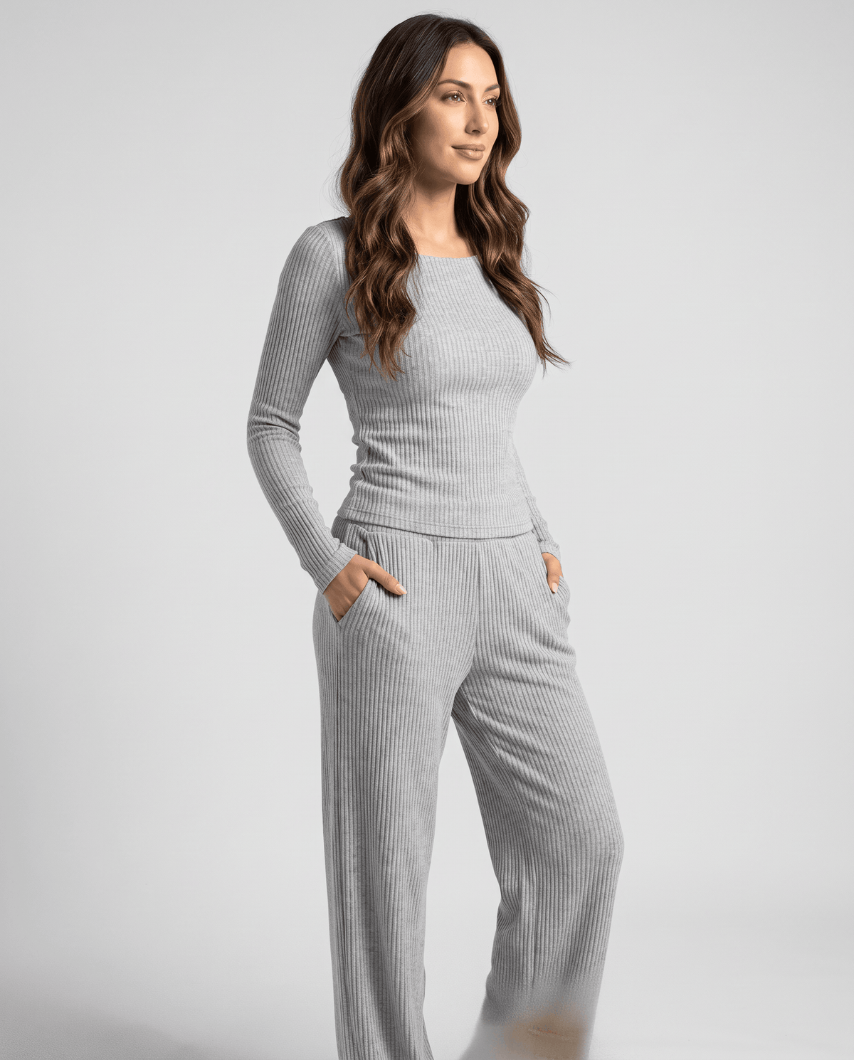 Gray ribbed set styled with hands in the wide-leg pants pockets, front three-quarter view
