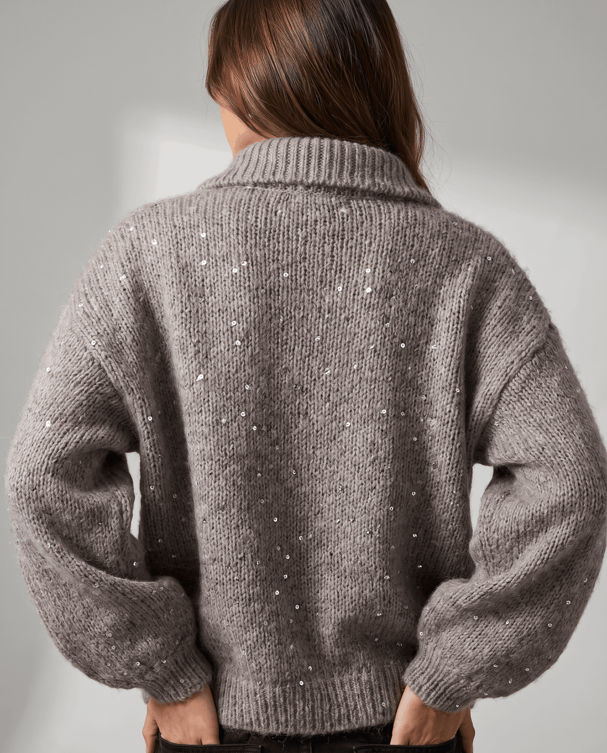Back view of the brown oversized cardigan with balloon sleeves and ribbed hem