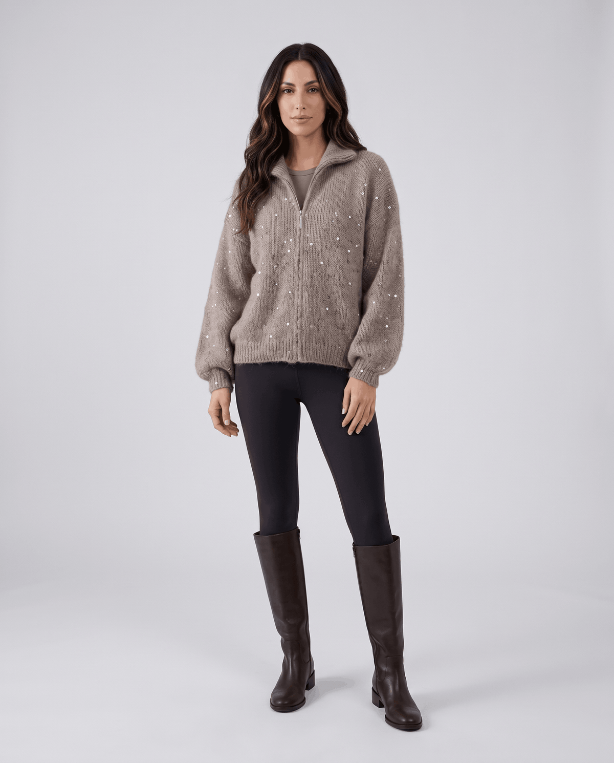 Full-length view of the brown cardigan with black leggings and tall dark brown boots