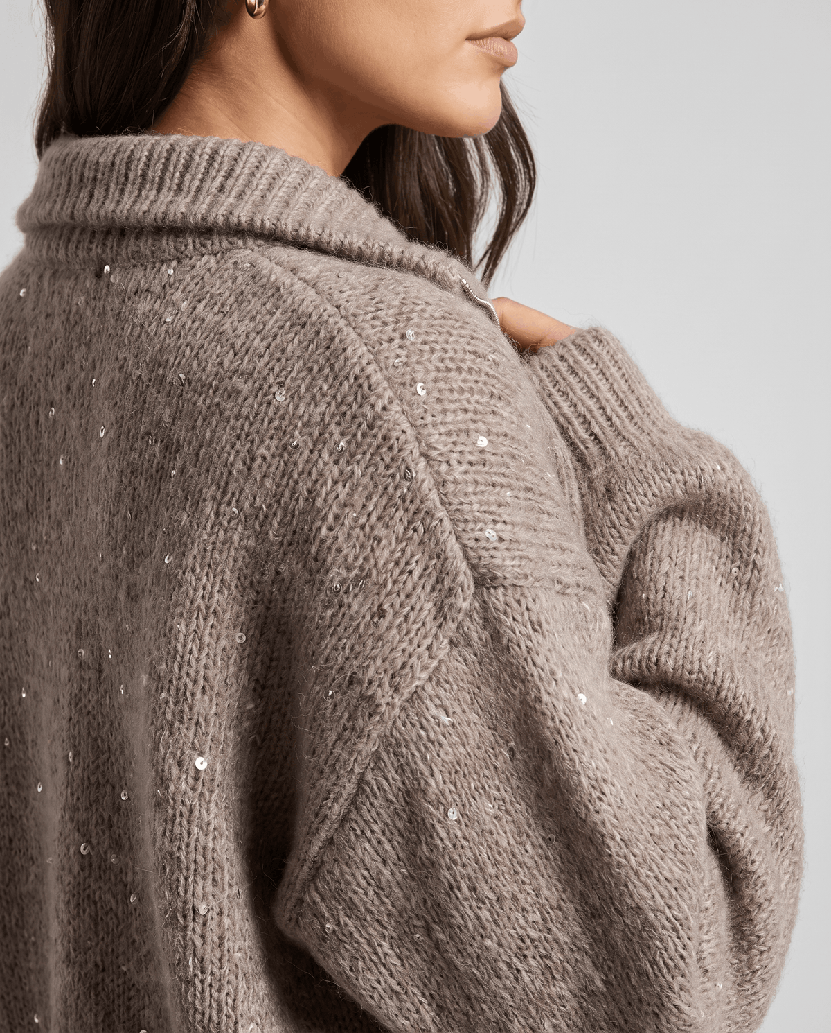 Shoulder detail of the brown cardigan showing fine sequins and dropped shoulder seam