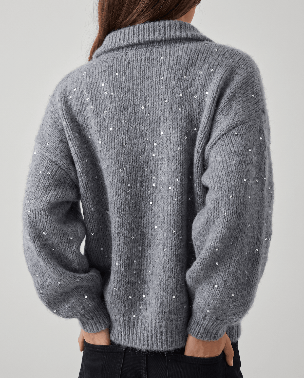 Back view of the gray cardigan showing sequins scattered across the knit