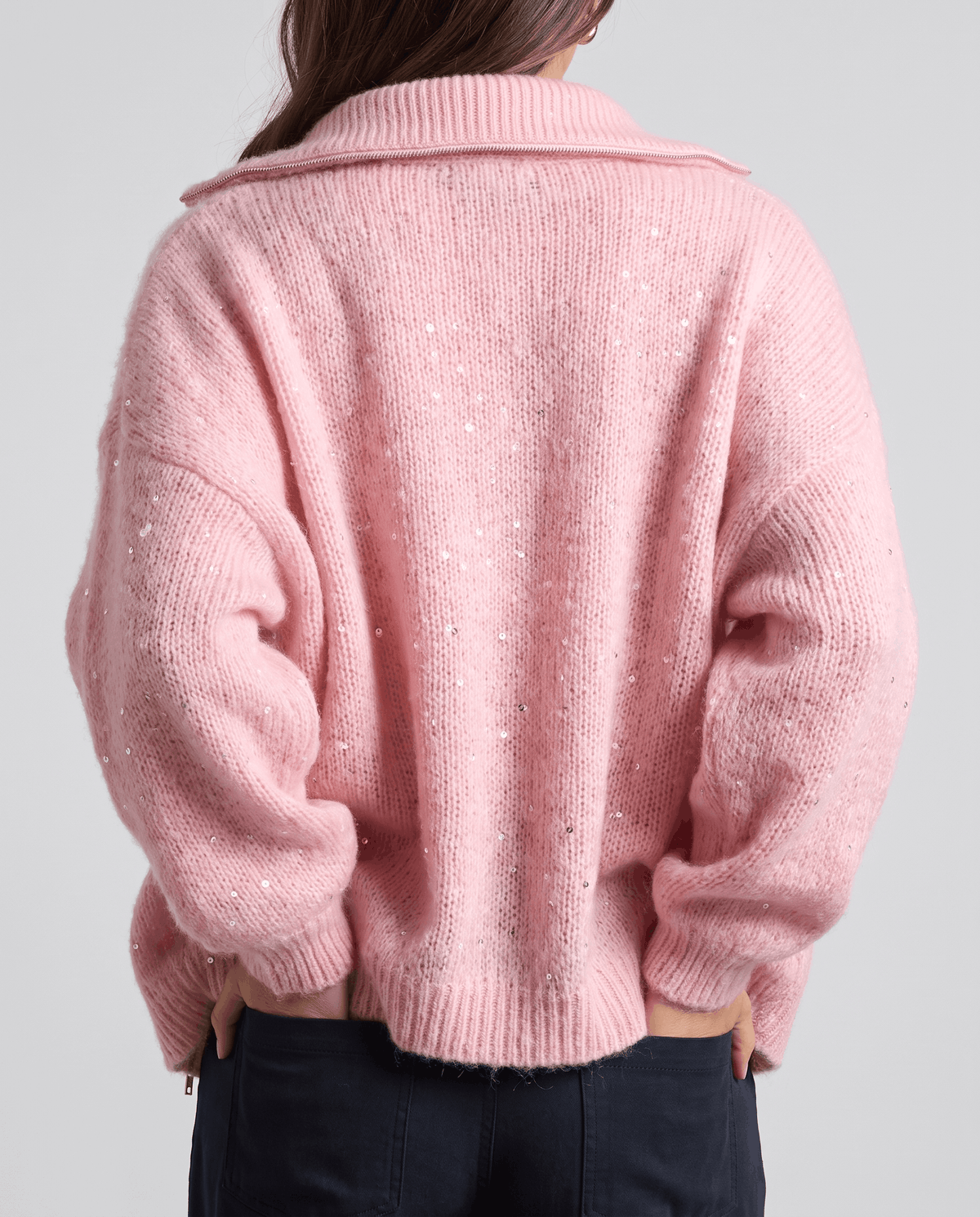Back view of the pink oversized cardigan with fold-over collar and ribbed hem