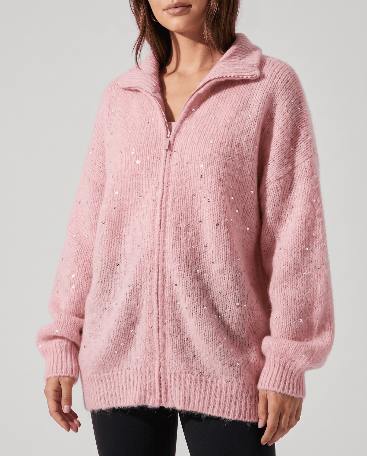 Front view of the oversized pink knit cardigan with balloon sleeves and ribbed cuffs