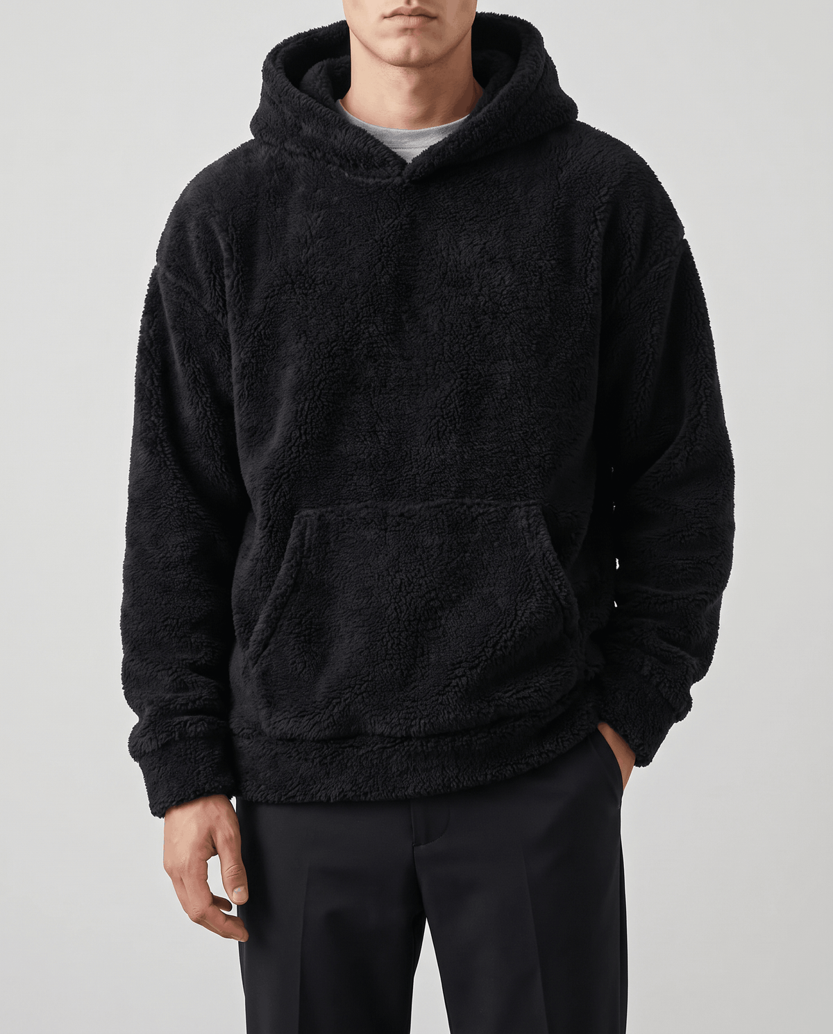 Front view of the black fuzzy hoodie showing the kangaroo pocket