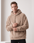 Men's sherpa fleece pullover hoodie in brown with hands clasped at the waist