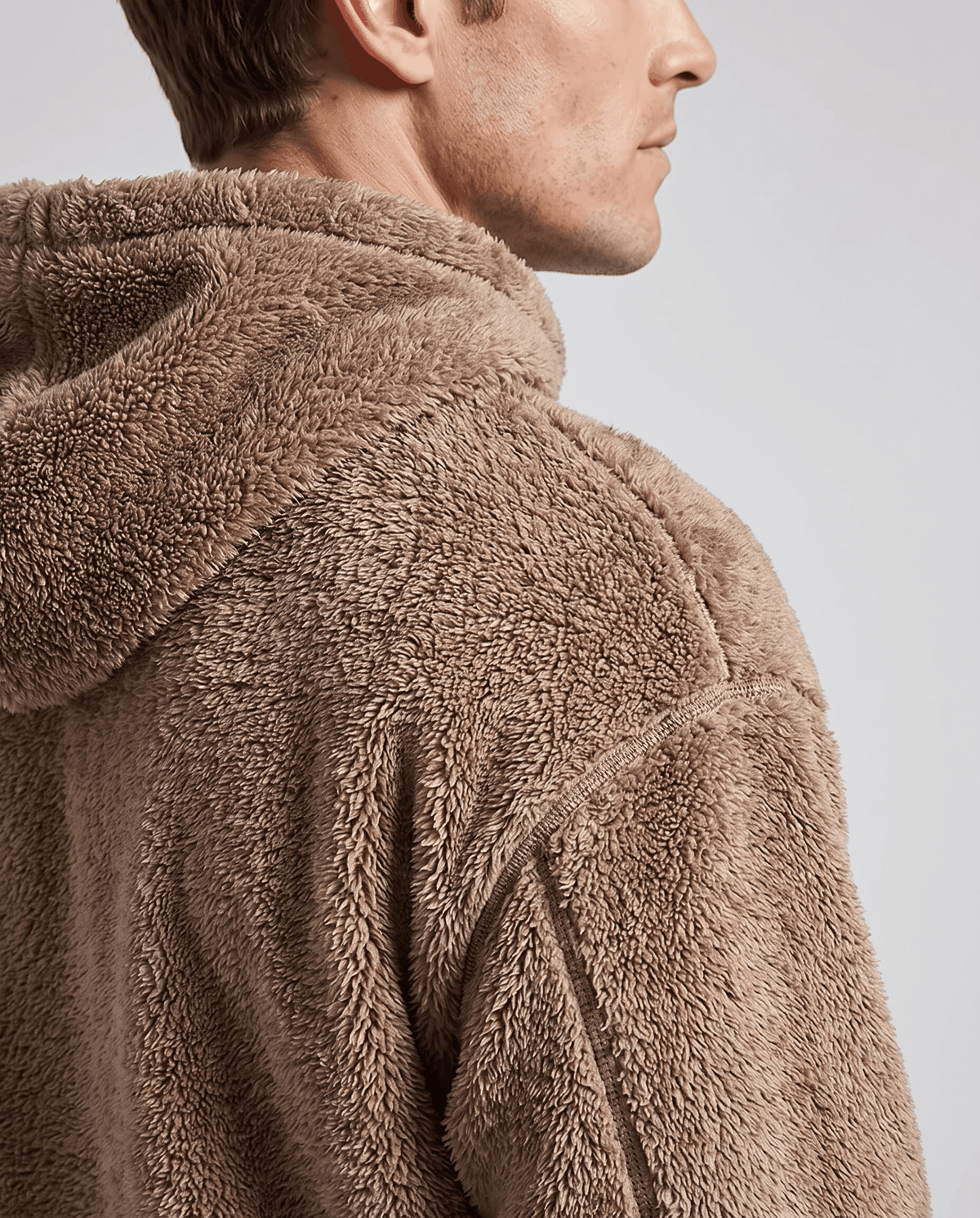 Back shoulder view of the brown hoodie showing the hood and fuzzy pile