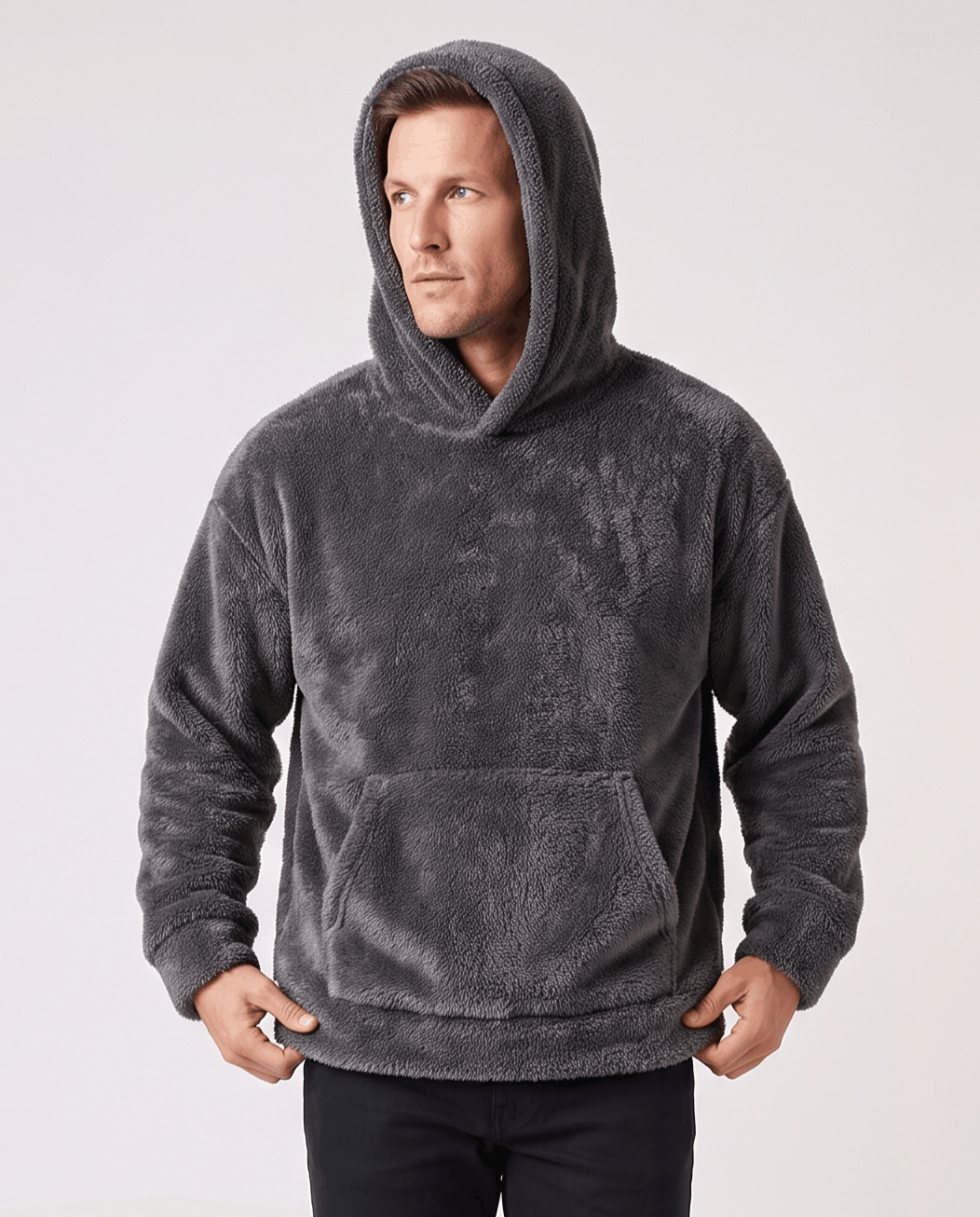 Gray hoodie worn with the hood up and hands at the pocket