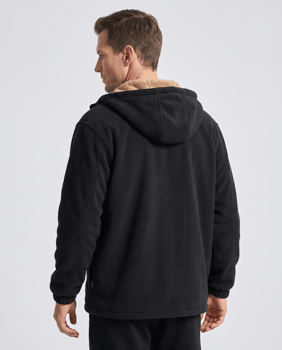 Back view of the black zip-up hoodie with ribbed cuffs and hem