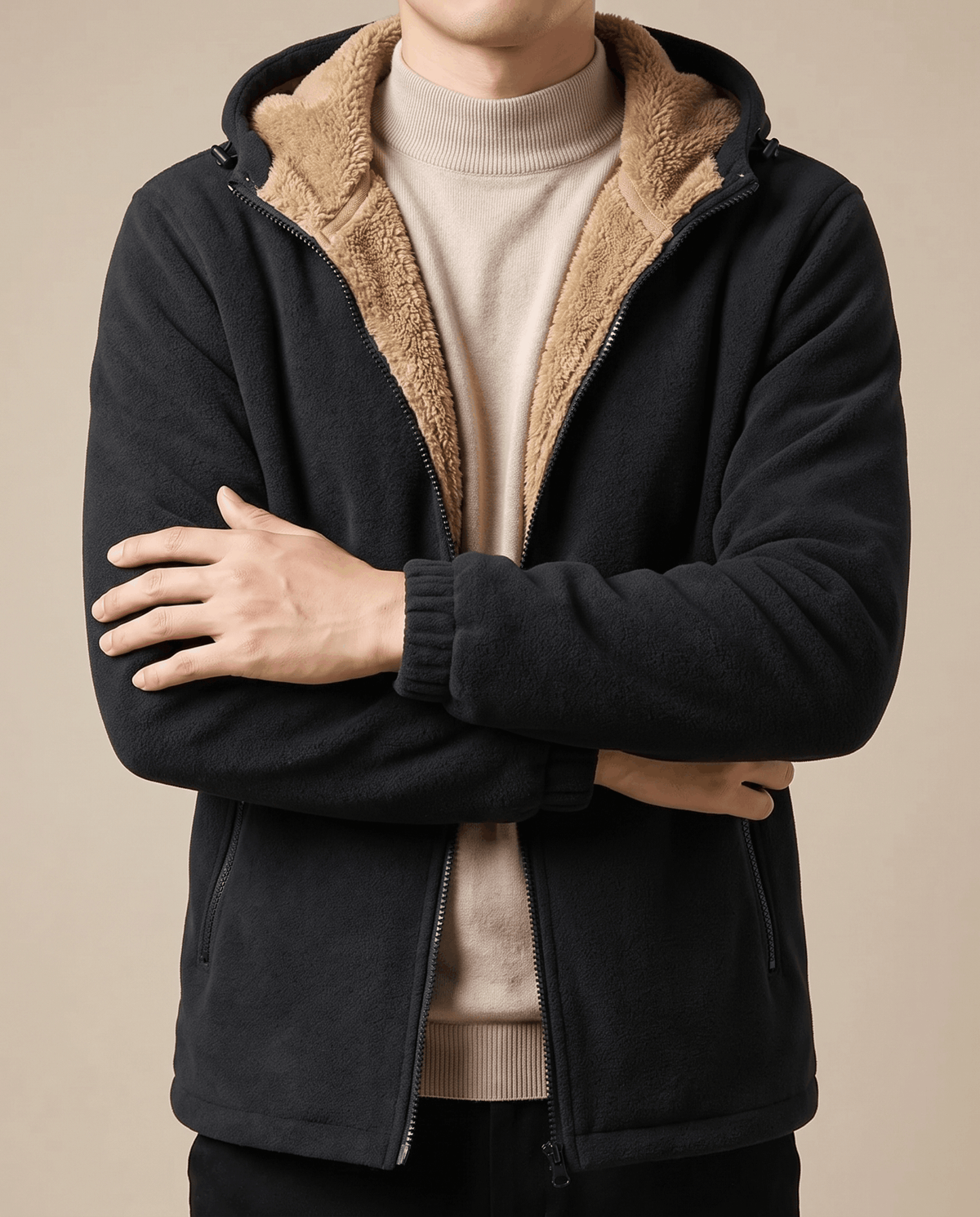 Black hoodie worn open over a cream turtleneck with arms crossed
