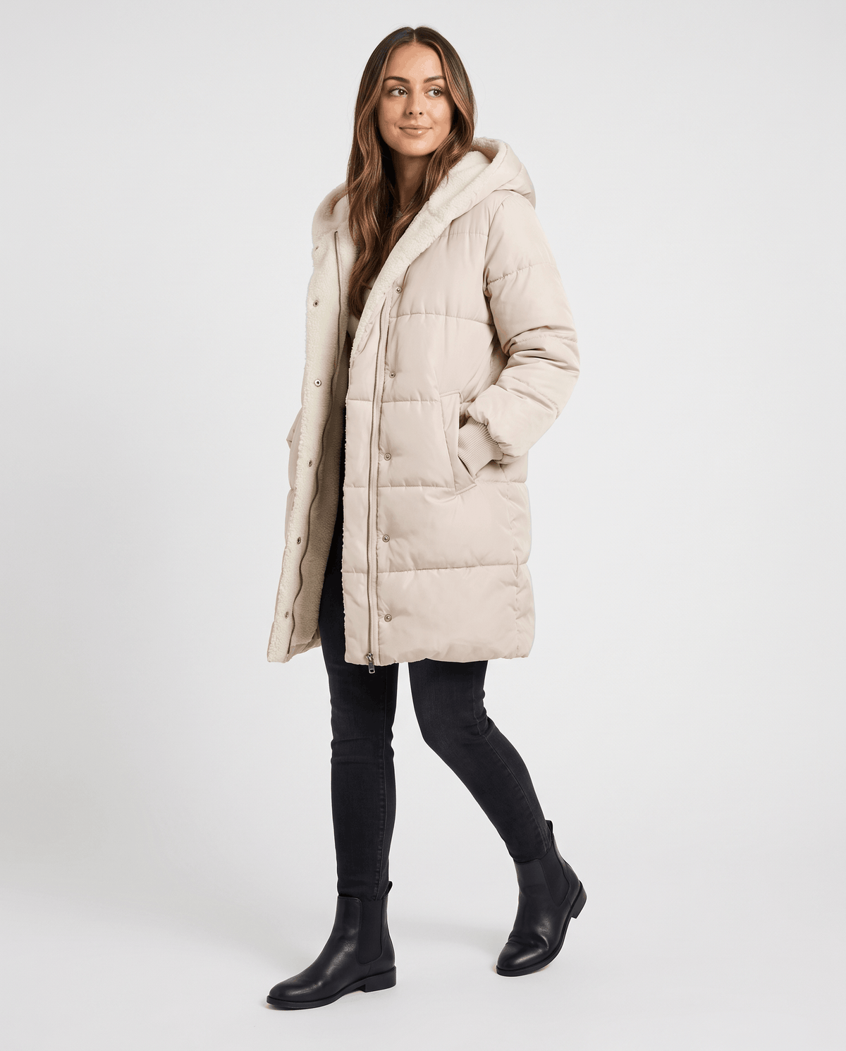 Full-length view of beige coat worn open with black jeans