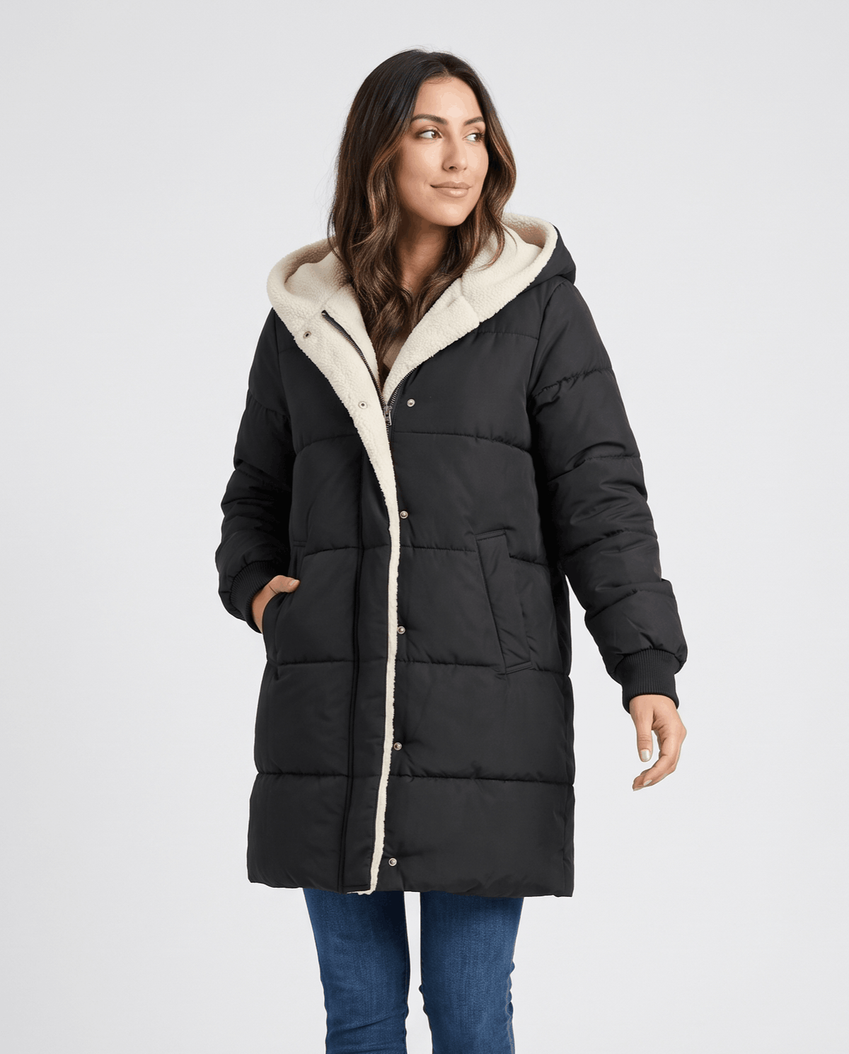 Woman in black sherpa-lined puffer coat with hand in side pocket