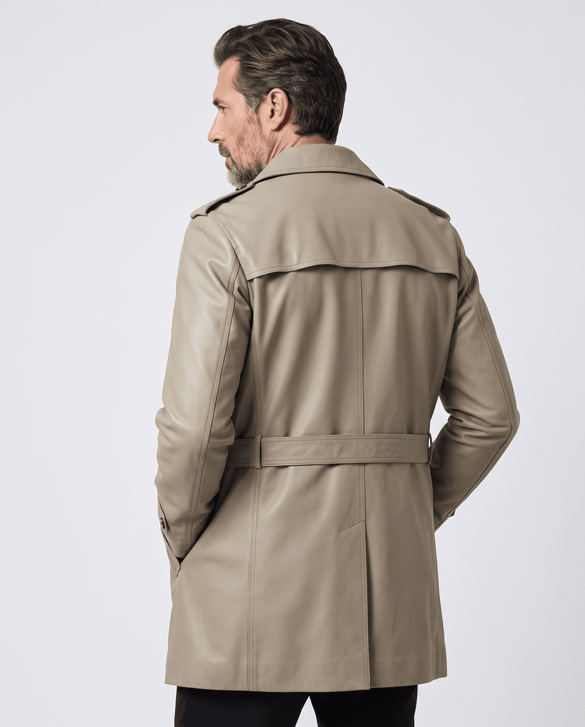 Back view of beige trench coat with storm yoke, epaulets and tie belt at the waist