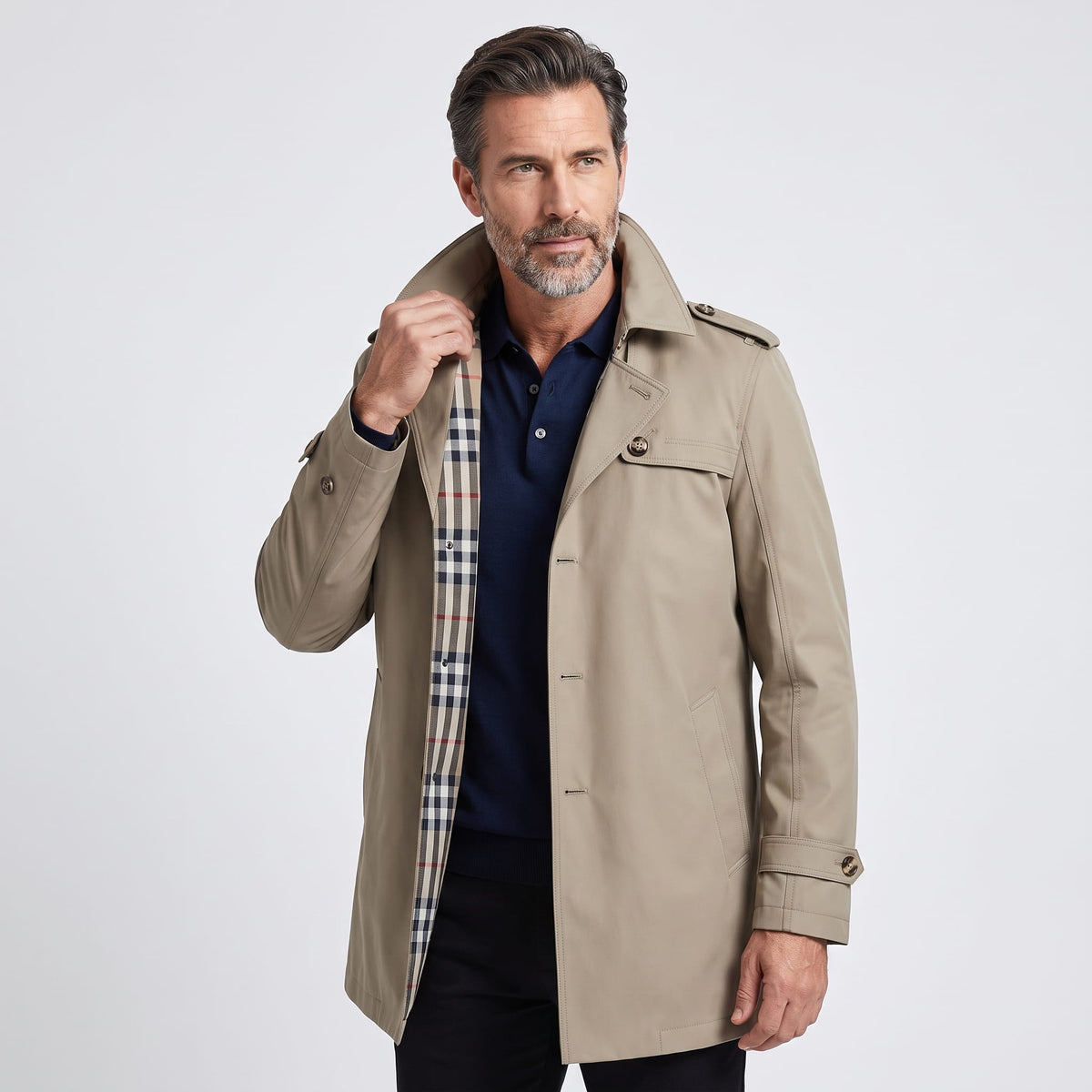 Single-breasted trench coat in beige worn open over a dark shirt, front view with epaulets